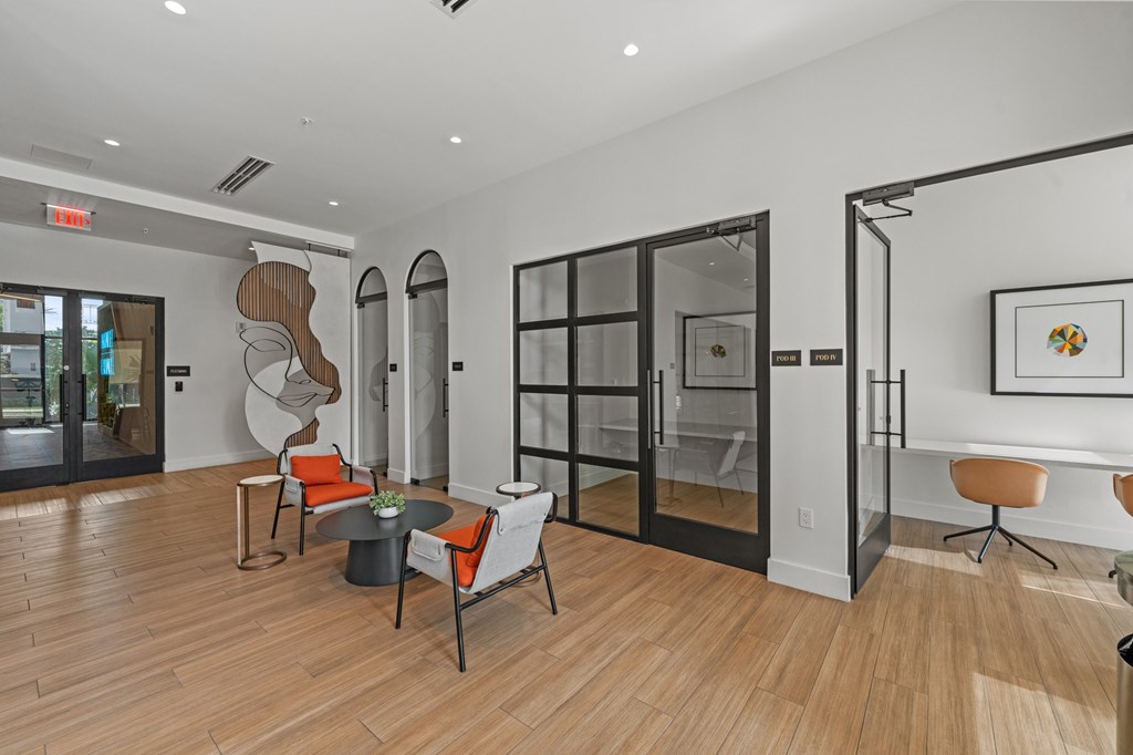 A modern living room with a wooden floor and a glass door.