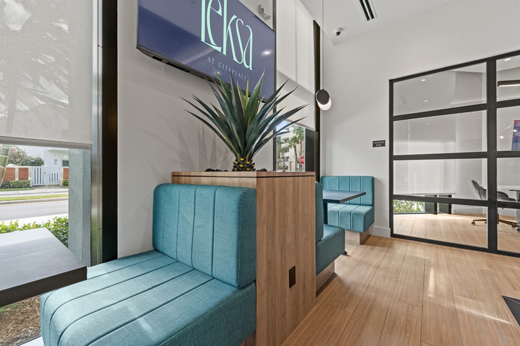 A blue couch is in the foreground of a modern office space.