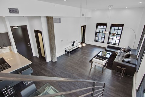A modern open concept living room with a kitchen area.