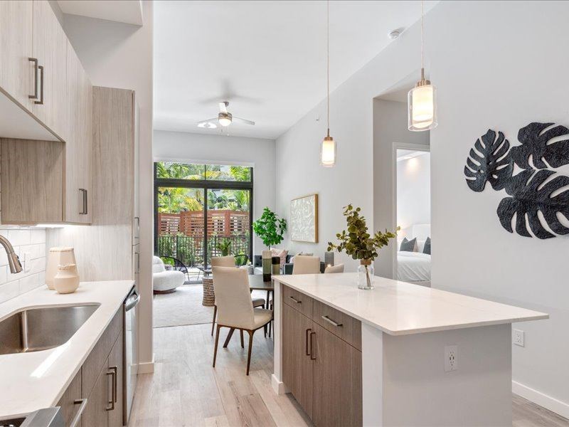 a kitchen with a large island next to a living room