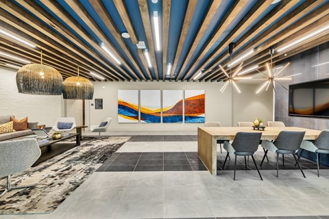 A modern dining room with a wooden table and chairs.