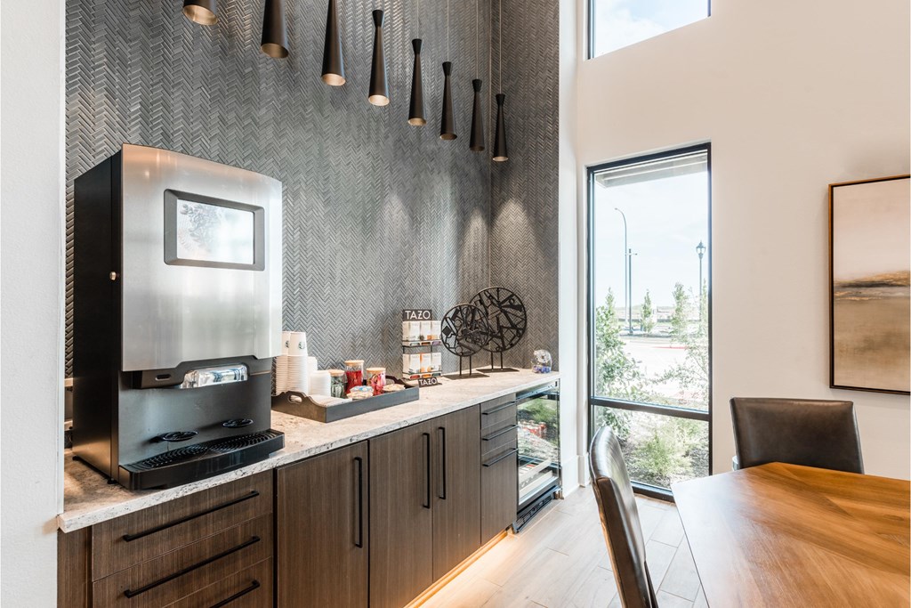 a kitchen with a coffee maker and a dining table