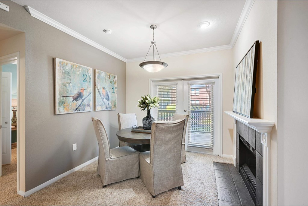 a dining room with a table and chairs and a fireplace