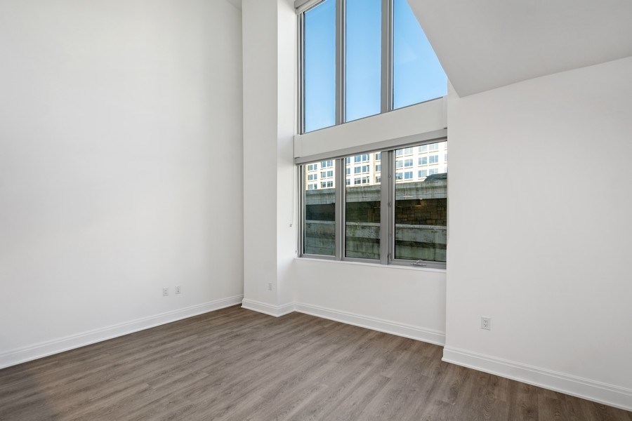 an empty room with white walls and a window