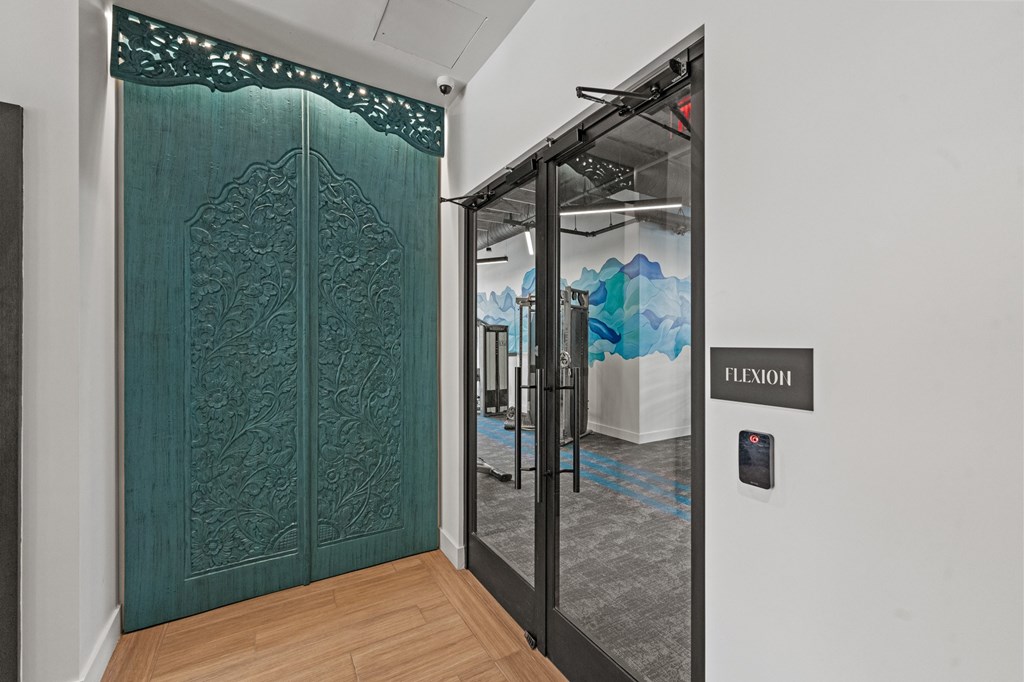 A green door with a glass window and a sign that says Flexioh.