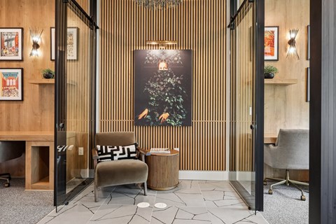 A modern office lobby with a wooden wall and a large poster.