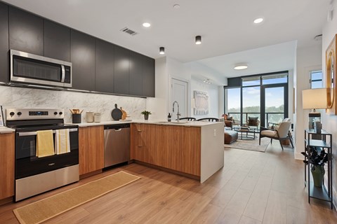 A modern kitchen with dark brown cabinets and a wooden island.
