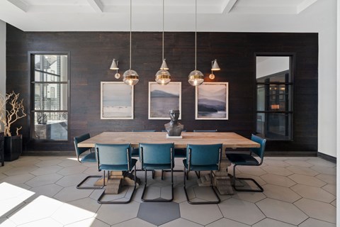 A dining room with a wooden table and blue chairs.