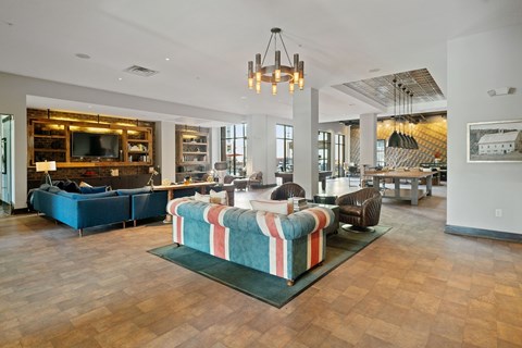 A living room with a striped sofa in the middle.