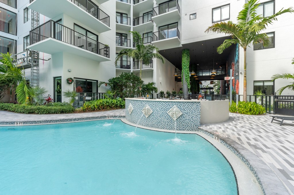 A modern building with a pool in front.