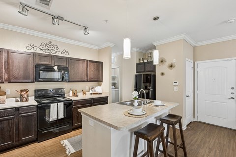 A kitchen with a white counter top and brown cabinets.