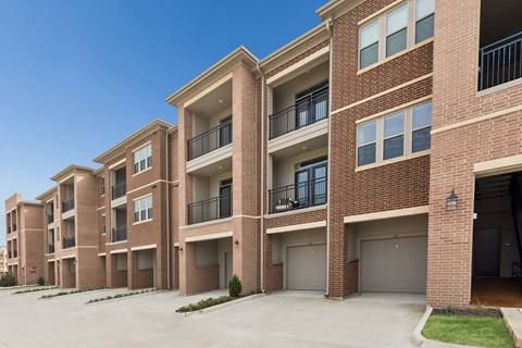 A row of apartment buildings with balconies and garages.