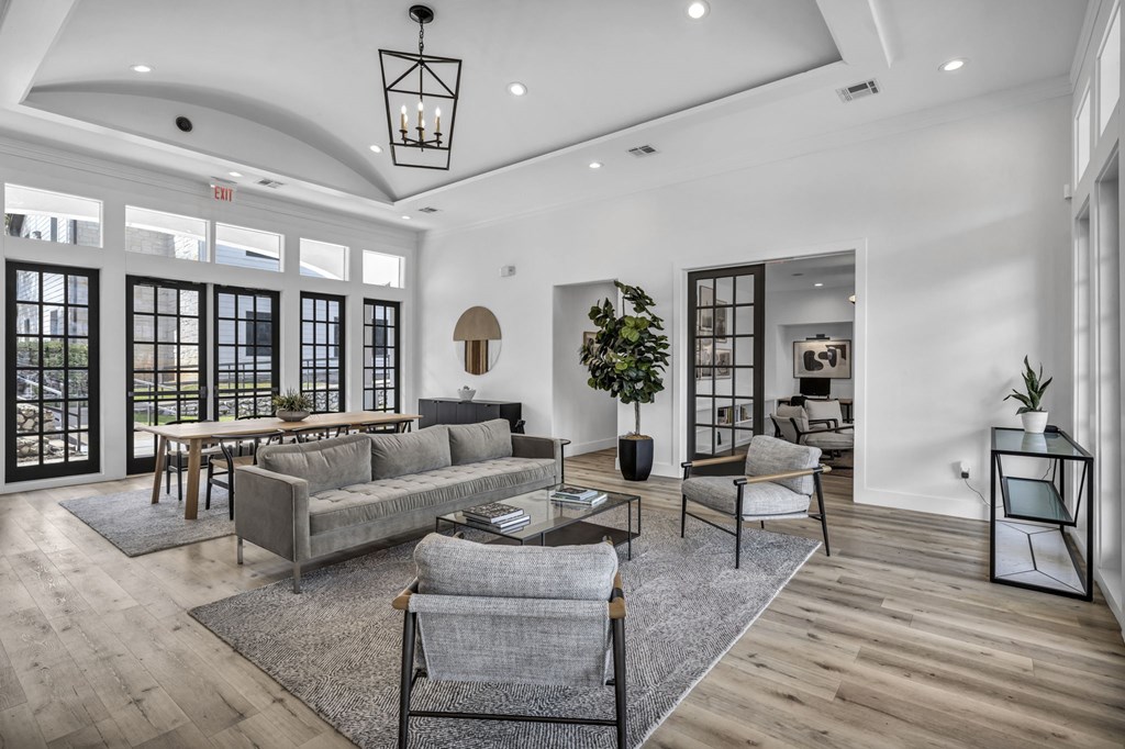 a living room filled with furniture and a large window