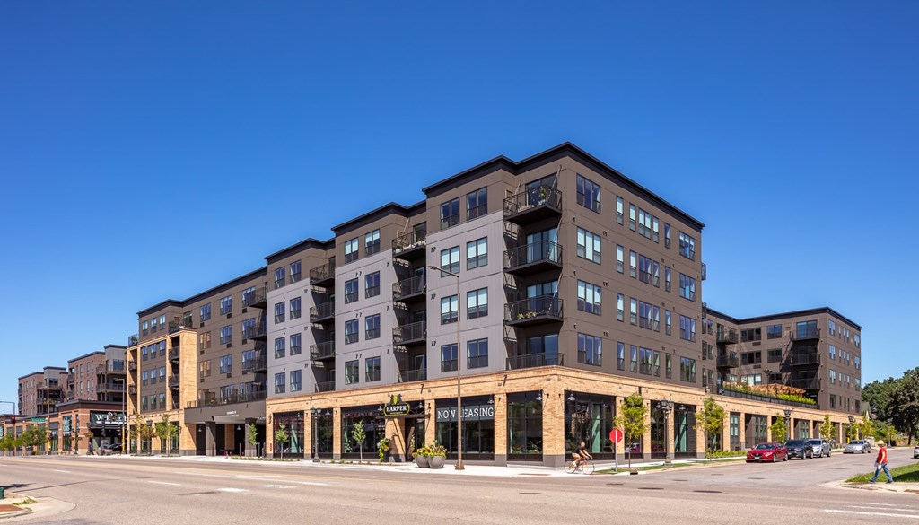 a large apartment building with a street in front of it