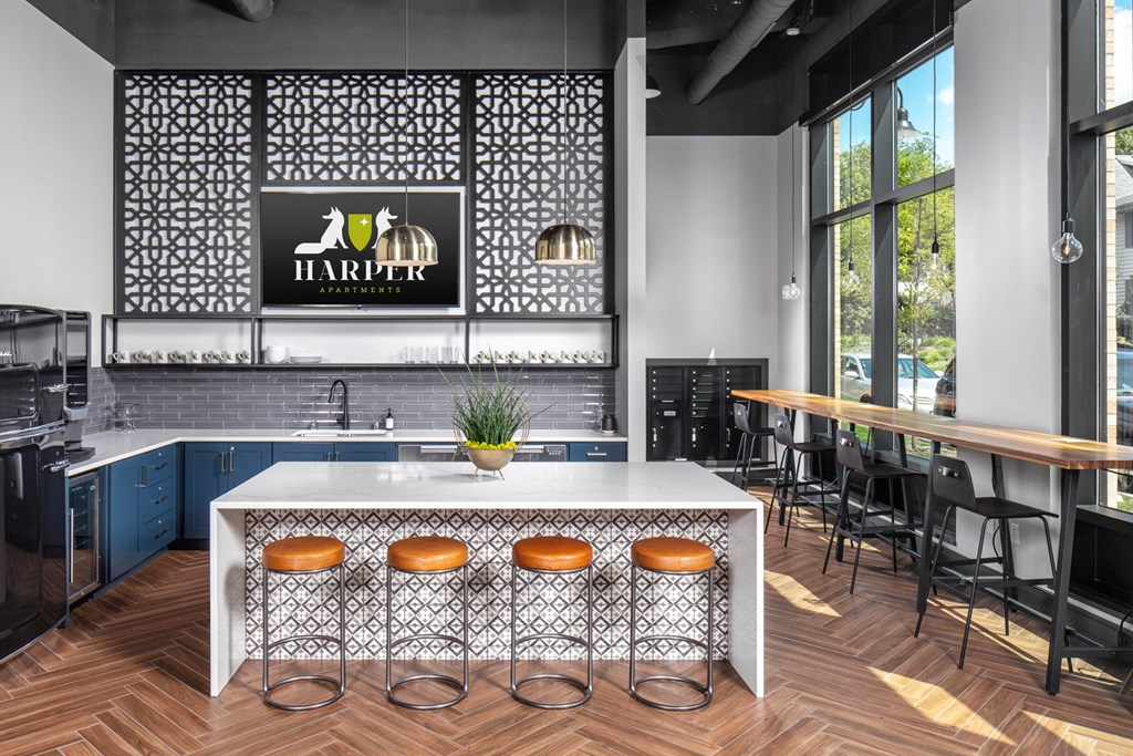 a kitchen with a large center island with stools in front of it