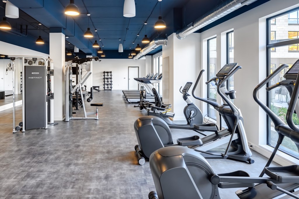 a gym with treadmills and other exercise equipment