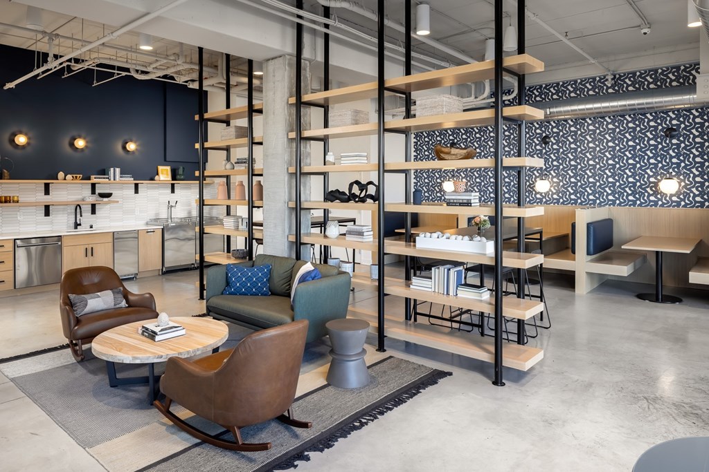 the lobby of a furniture store with chairs and tables