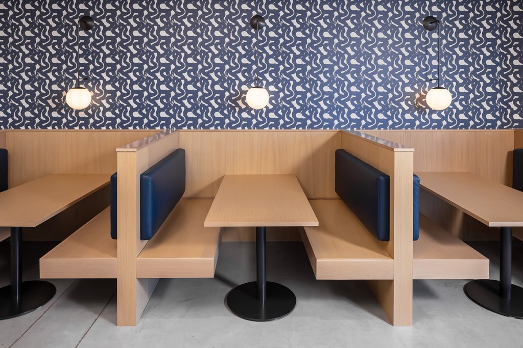 a rendering of a booth with tables and chairs in a restaurant