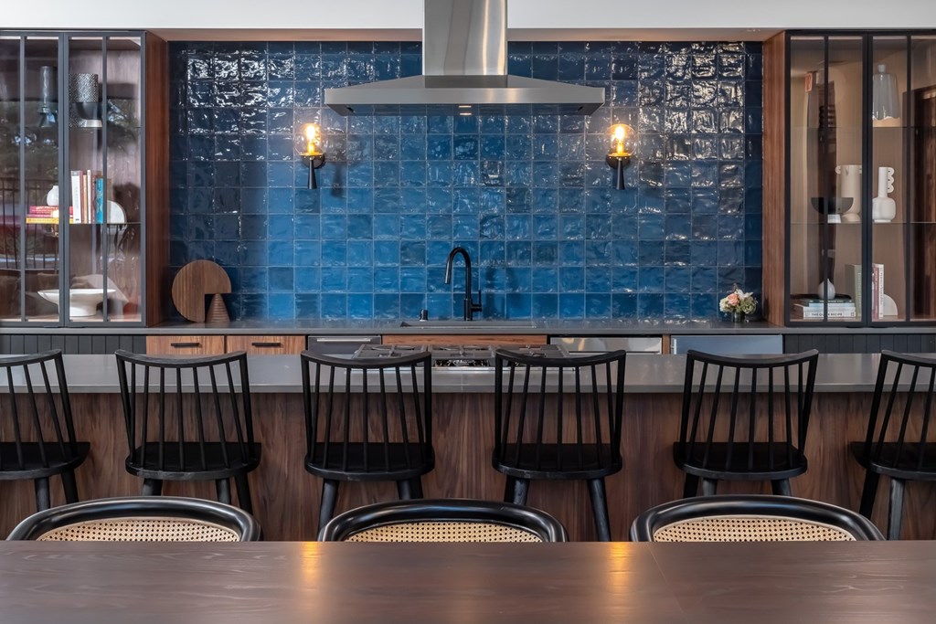 a bar with black chairs and a wooden table
