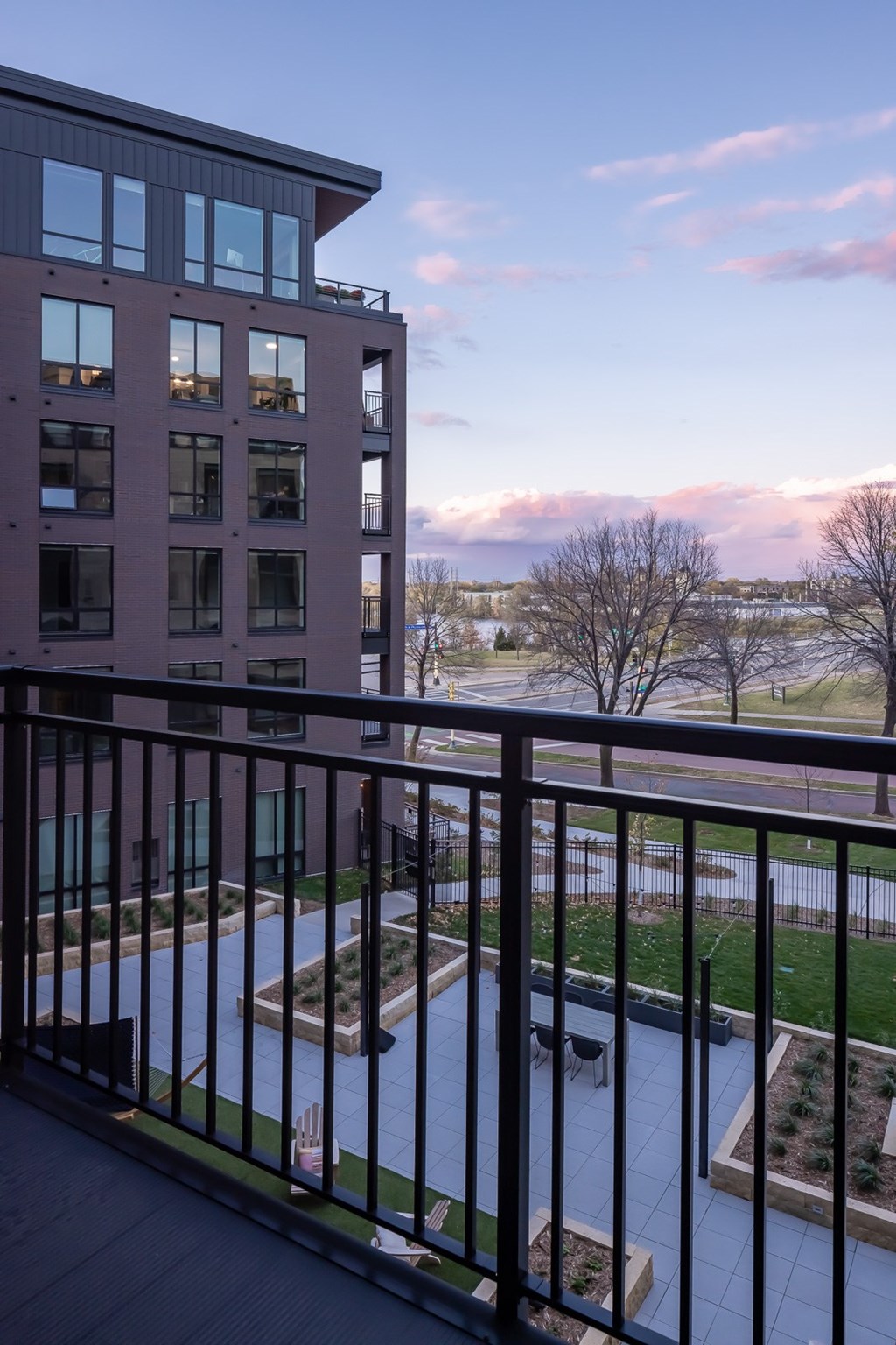 a balcony with a view of a building and a fence