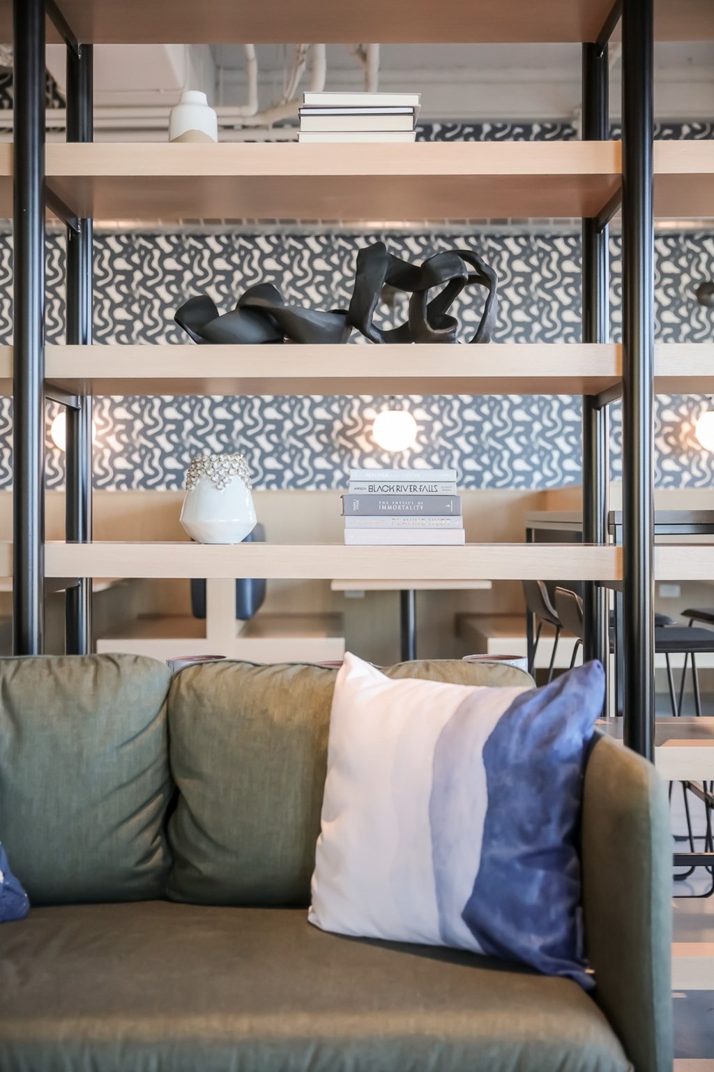 a living room with a couch and a shelf with pillows