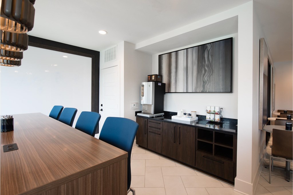 a dining room with a table and chairs and a kitchen
