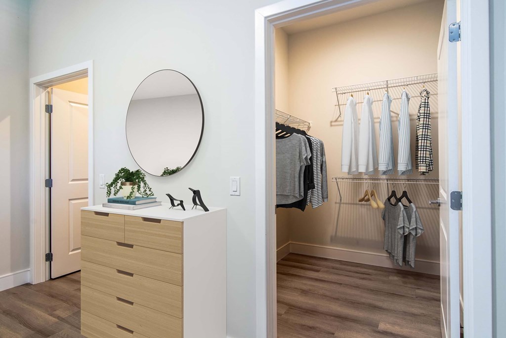 The Beacon furnished bedroom with a walk-in closet with shelving