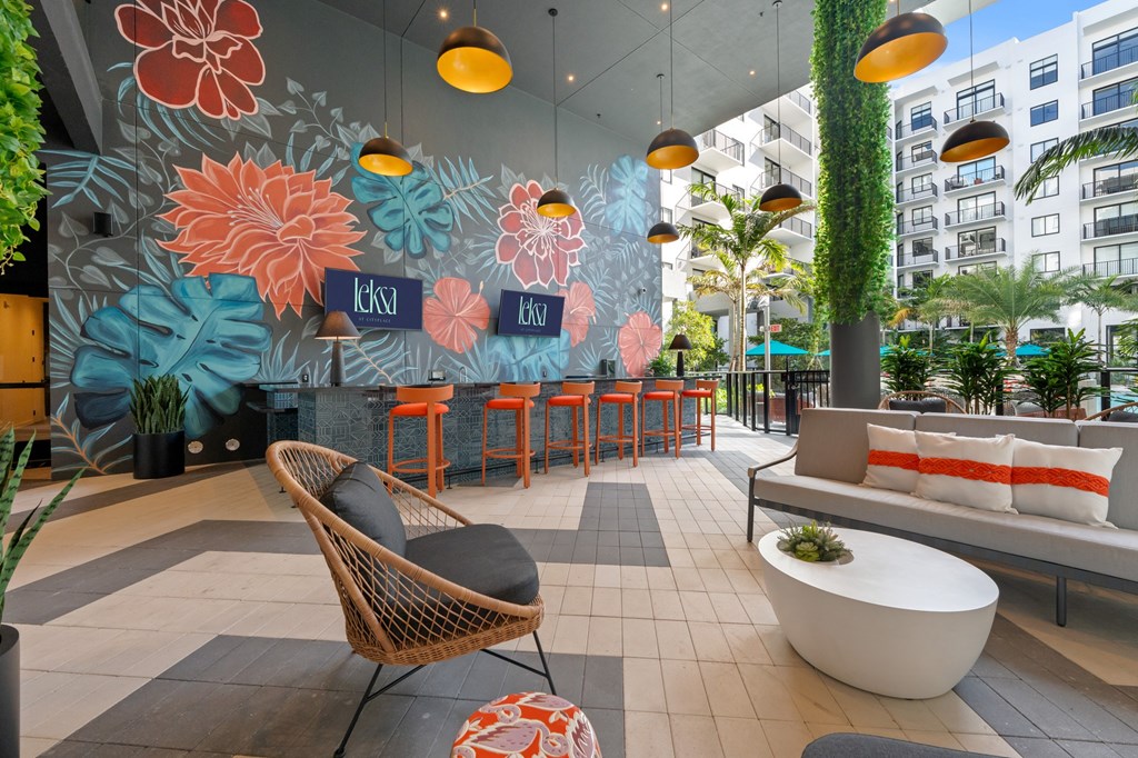 A modern outdoor seating area with a vibrant mural of flowers.