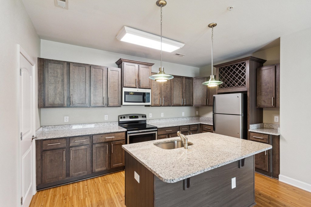a kitchen with wooden cabinets and granite countertops