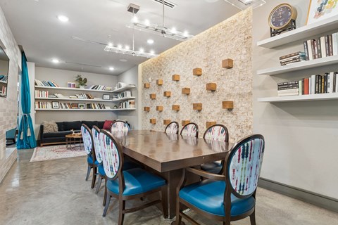 A dining room with a wooden table and chairs.
