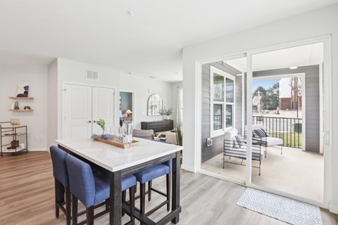 A dining area with a table and chairs is shown.