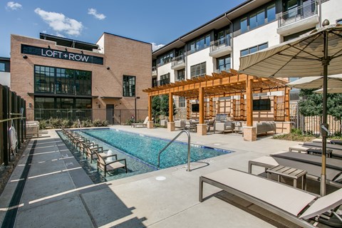 A pool area with a sign that says "LOFT + ROW".