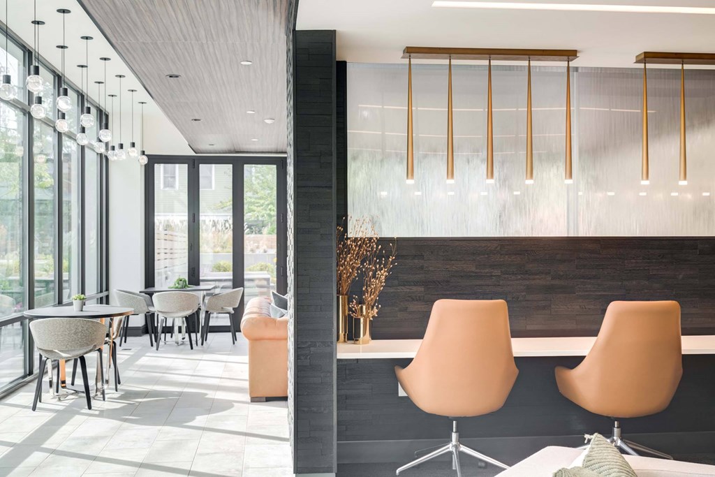 A modern dining area with a long table and chairs.