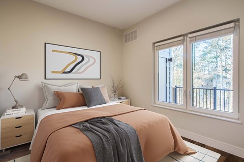The Beacon furnished bedroom with window next to the balcony with a storage closet