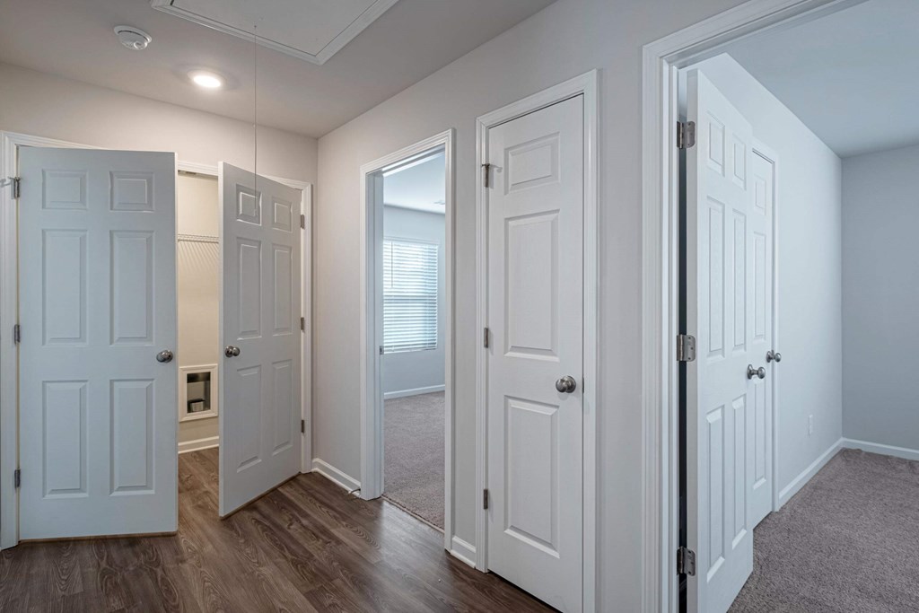 a bedroom with two closets and a door to a bathroom