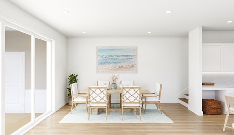 A dining room with a table set for four.