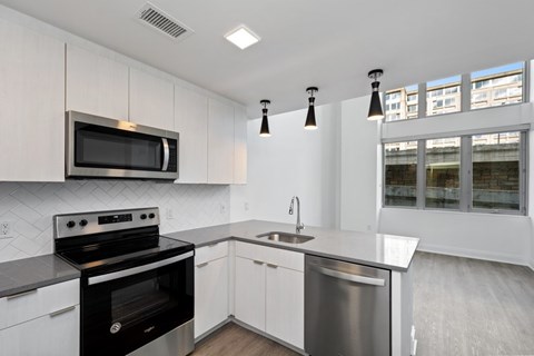 a kitchen with stainless steel appliances and white cabinets