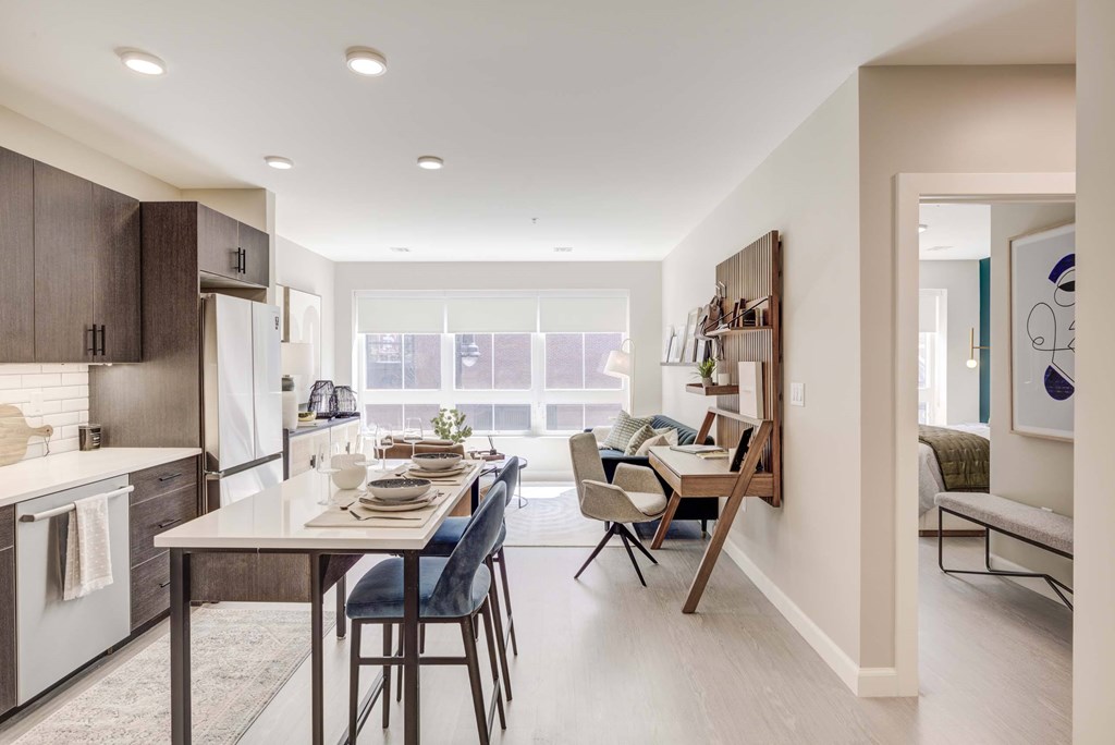 A modern kitchen with a dining table and chairs.