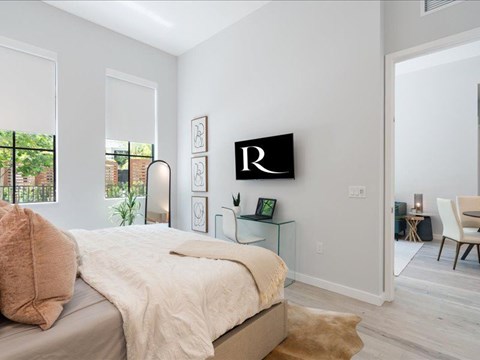 a bedroom with a bed and a window