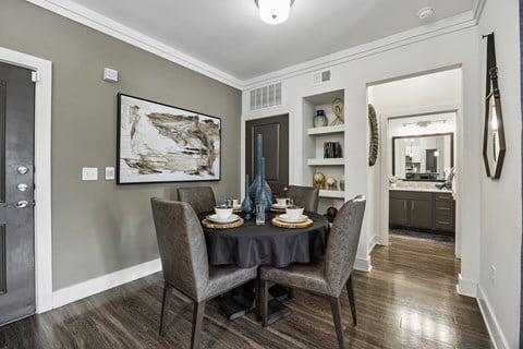 A dining room with a table set for two.