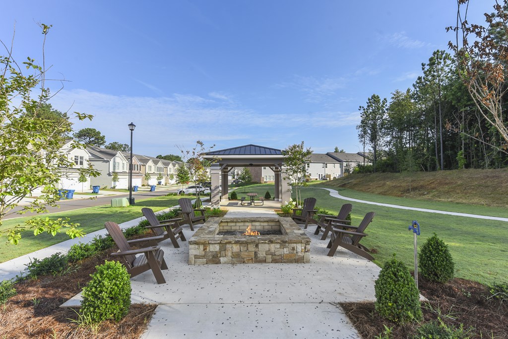 a park with benches and a fire pit