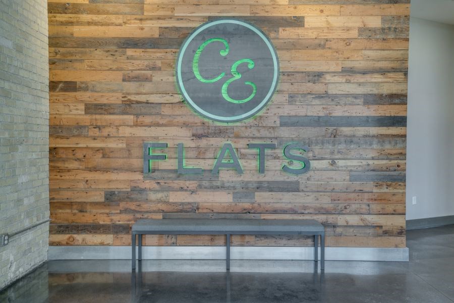 CE Flats logo on wooden wall in lobby