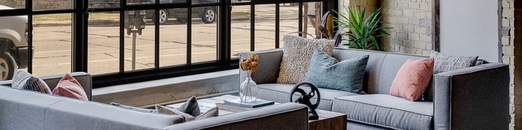 Exposed brick and warehouse windows in restored lobby space