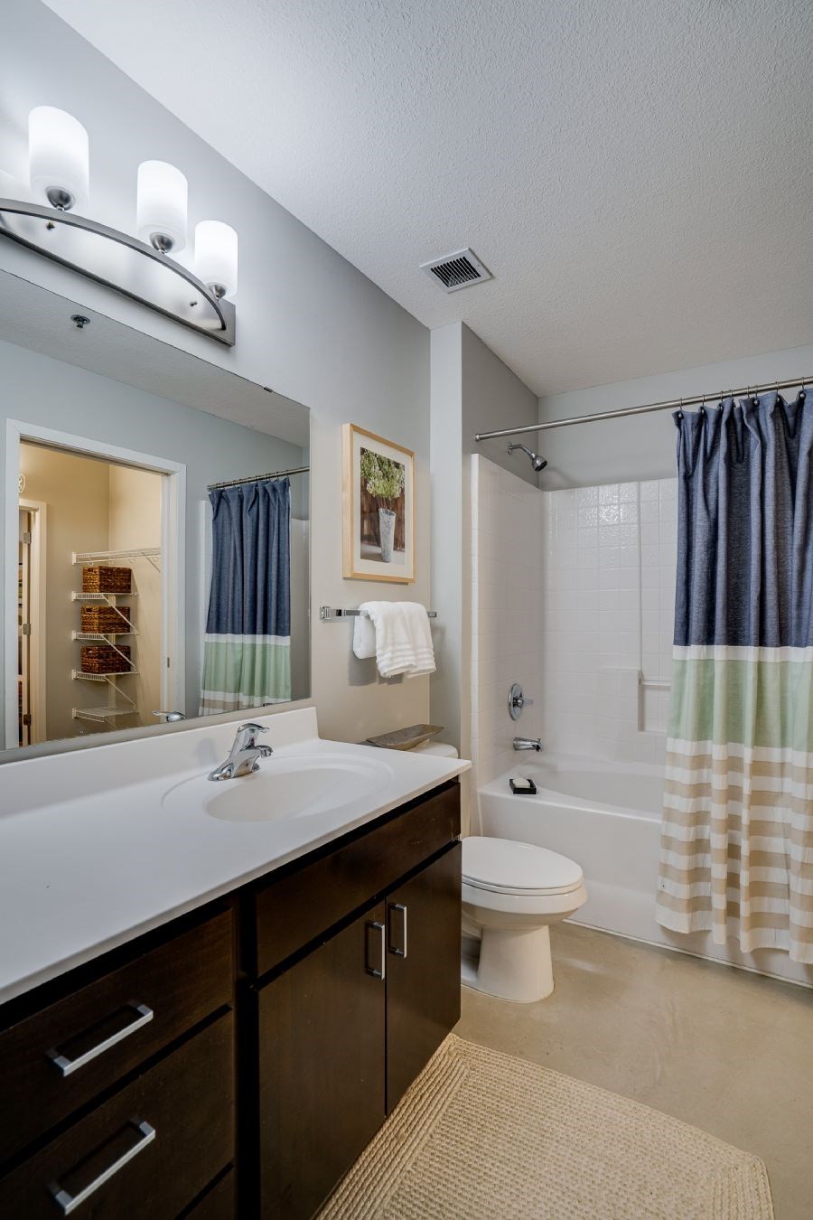 Loft style bedroom with bathtub and vanity