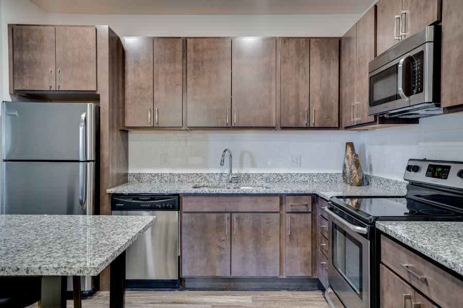 Flats Kitchen with granite countertops and dark wood cabinets