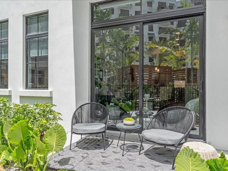 a patio with three chairs and a table