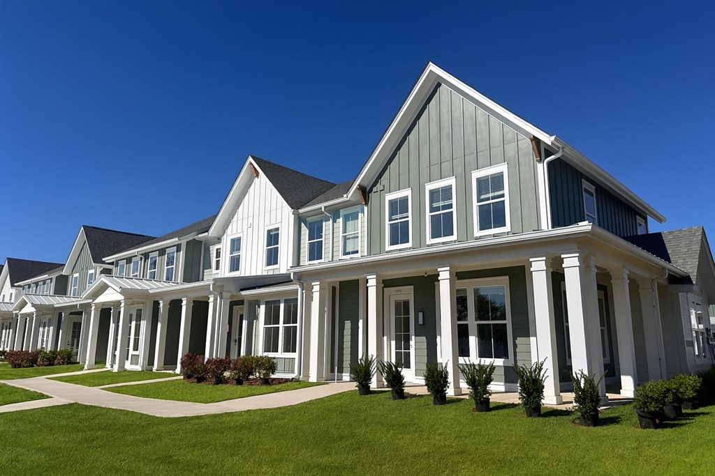 A row of houses with white columns in front.