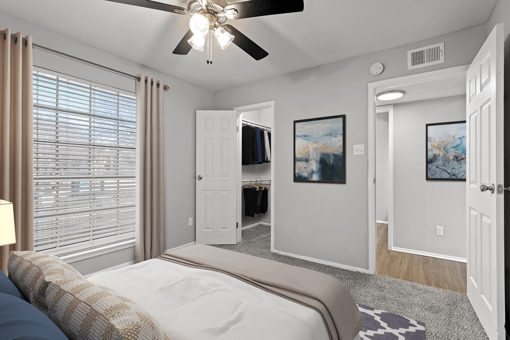 a bedroom with a bed and a ceiling fan