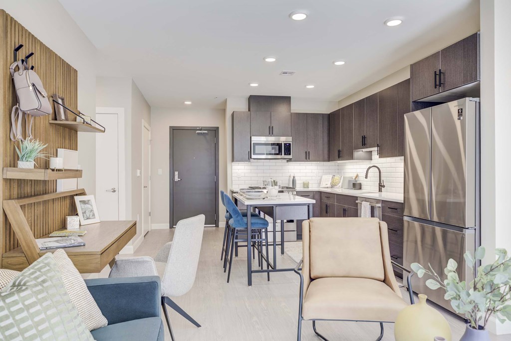 A modern kitchen with a dining table and chairs.