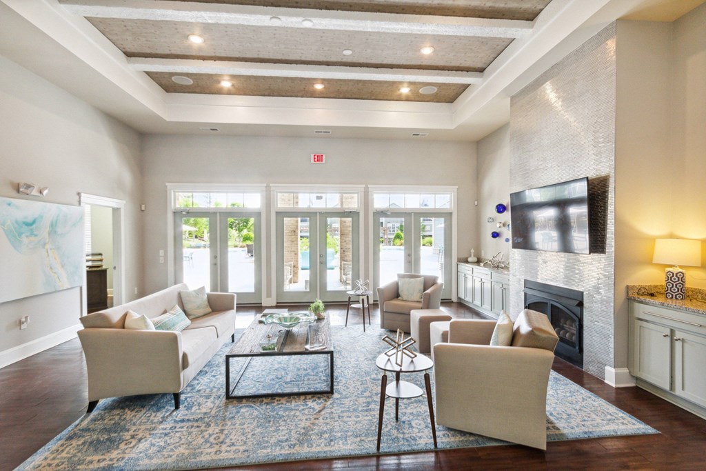 a living room with couches a coffee table and a fireplace